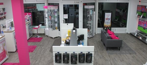 Modernes Telekommunikationsgeschäft mit Technikprodukten, Beratungstresen und Fernsehern.